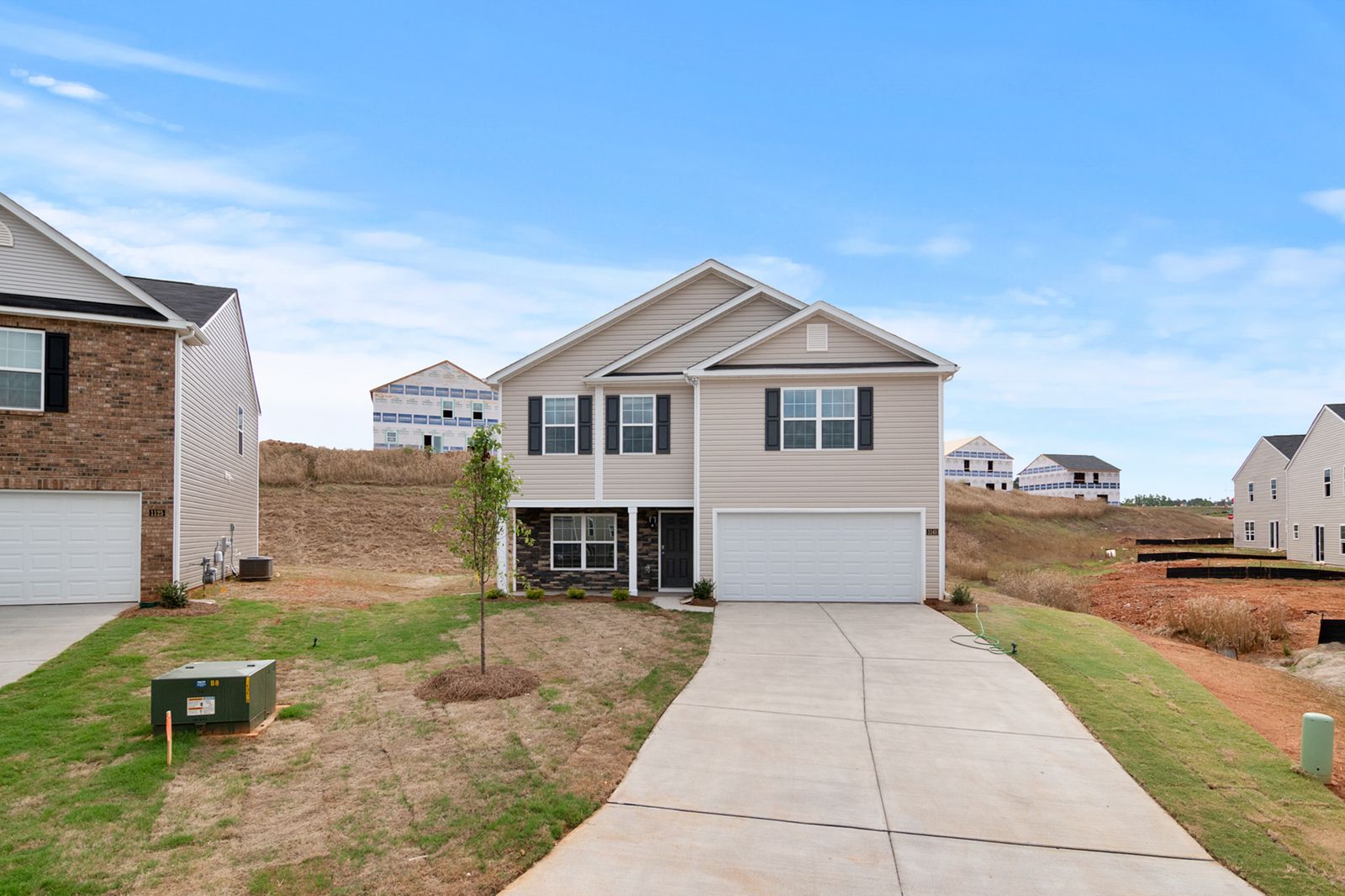 A concrete driveway leading to a residential garage