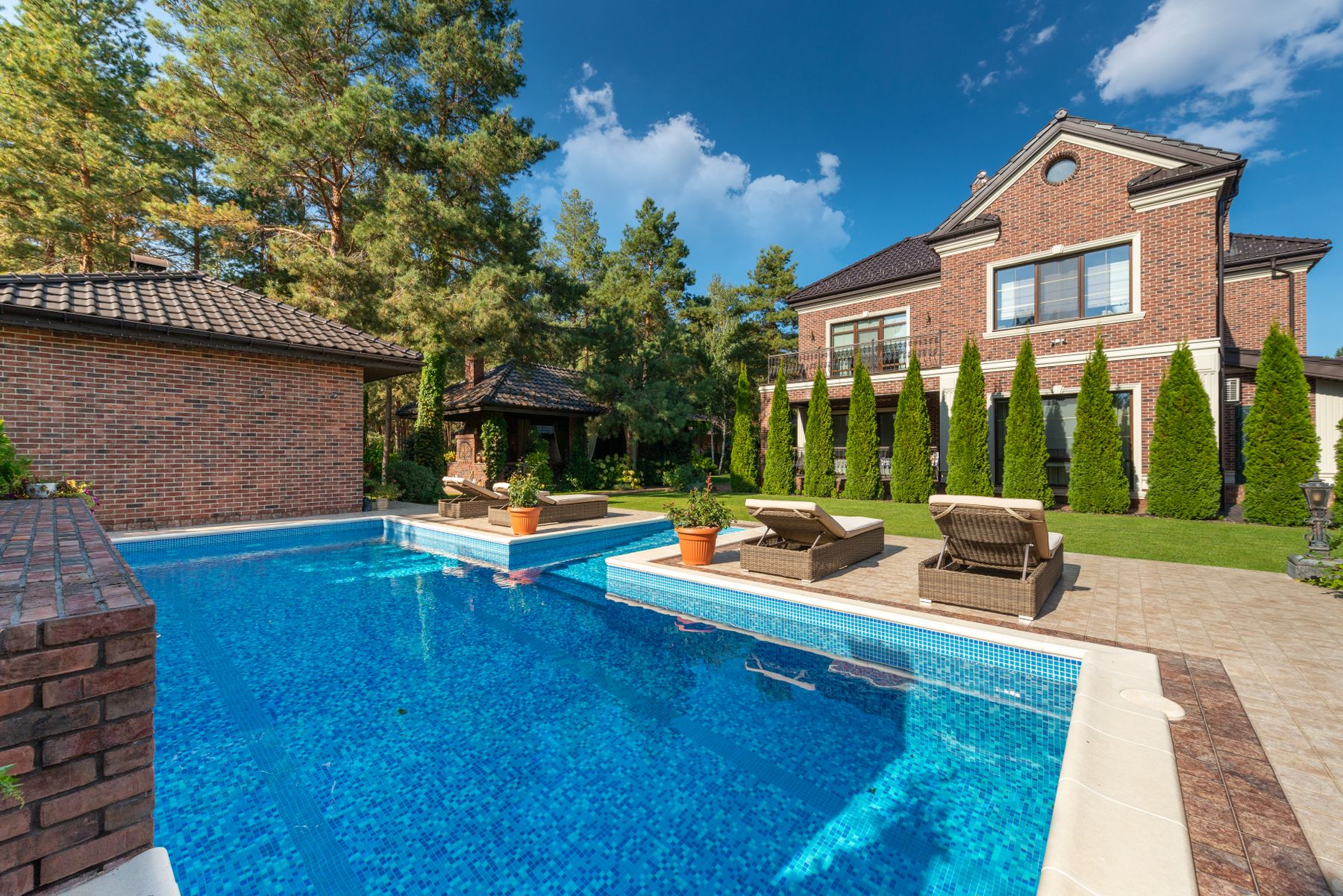 A residential pool and terrace with outdoor seating